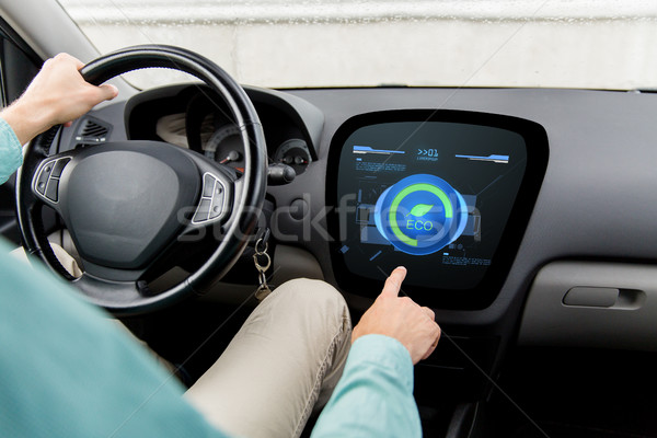 man driving car with eco mode on board computer Stock photo © dolgachov