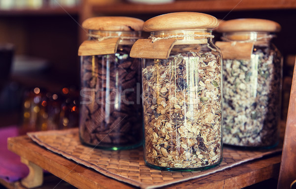 close up of jars with granola at grocery store Stock photo © dolgachov