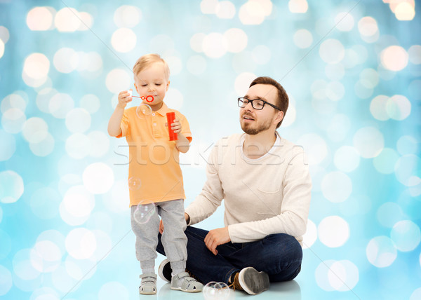 Stock photo: father with son blowing bubbles and having fun