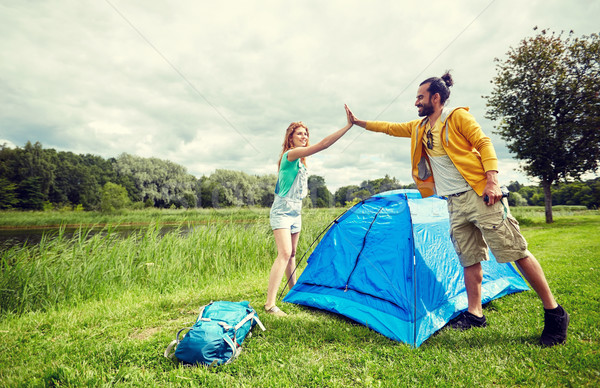 happy couple setting up tent outdoors Stock photo © dolgachov