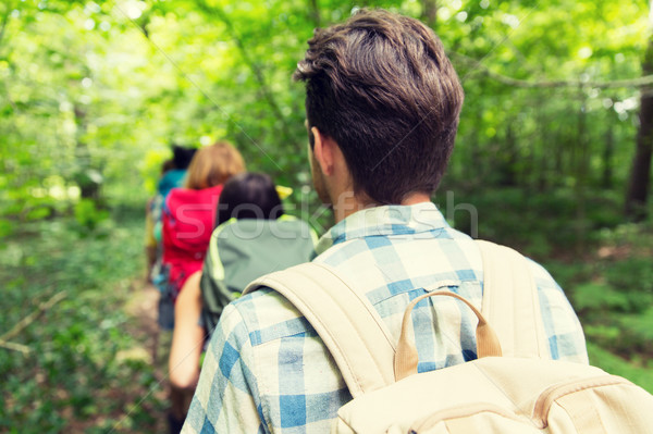 close up of friends with backpacks hiking Stock photo © dolgachov