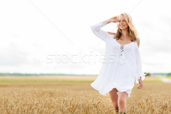 smiling young woman in white dress on cereal field Stock photo © dolgachov