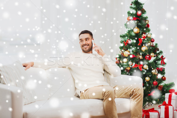 man calling on smartphone at home for christmas Stock photo © dolgachov