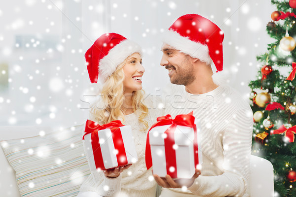 happy couple at home exchanging christmas gifts Stock photo © dolgachov