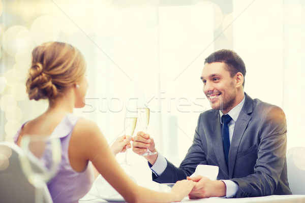couple with glasses of champagne at restaurant Stock photo © dolgachov