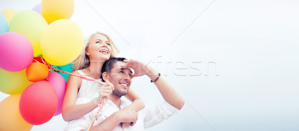 couple with colorful balloons at seaside Stock photo © dolgachov