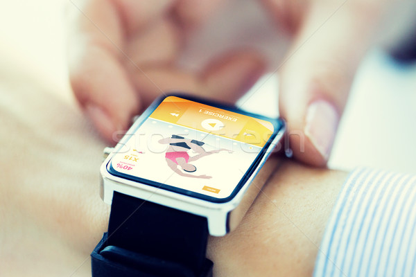 close up of hands setting sport app on smartwatch Stock photo © dolgachov