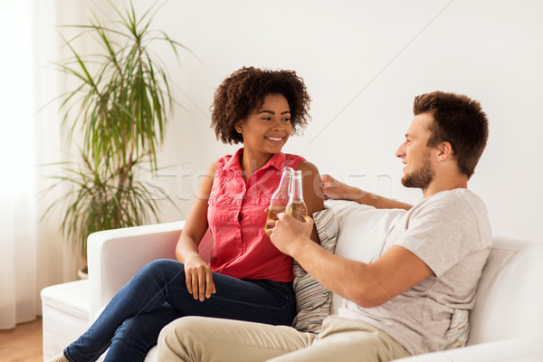 happy friends or couple with beer talking at home Stock photo © dolgachov