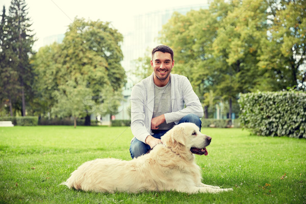 happy man with labrador dog walking in city Stock photo © dolgachov