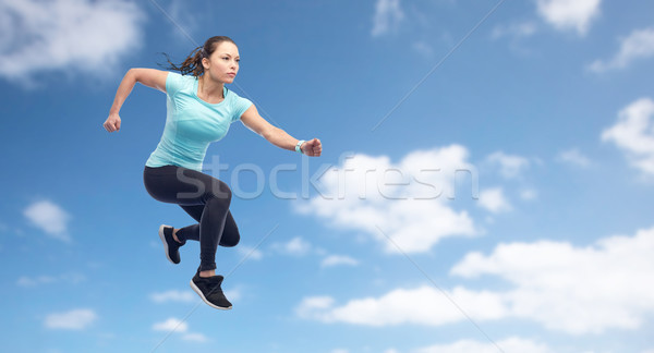 happy sporty young woman jumping in air Stock photo © dolgachov