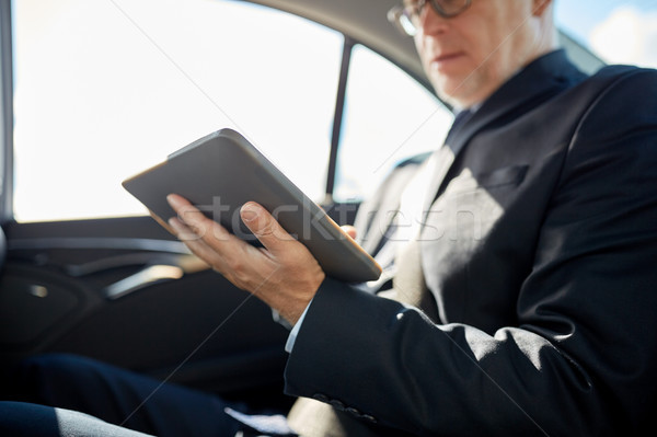 senior businessman with tablet pc driving in car Stock photo © dolgachov