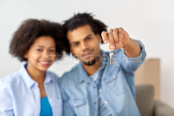 happy couple with key and boxes moving to new home Stock photo © dolgachov