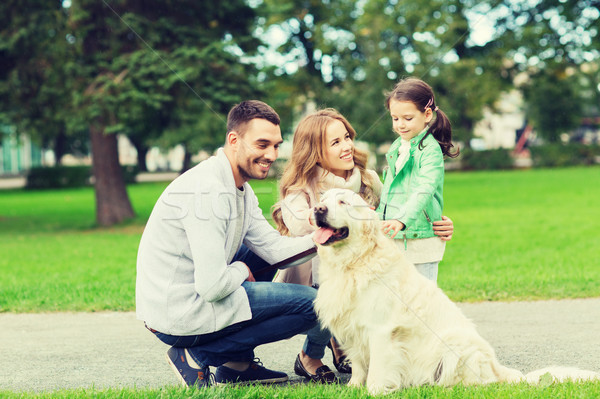 happy family with labrador retriever dog in park Stock photo © dolgachov