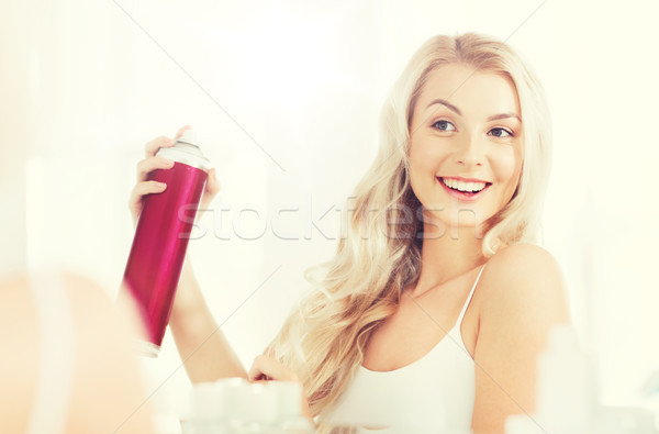 woman with hairspray styling her hair at bathroom Stock photo © dolgachov