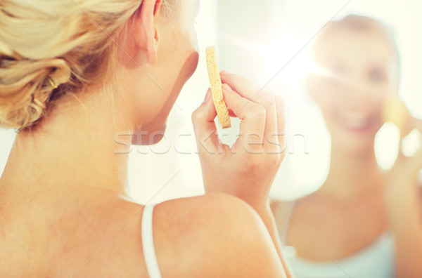 close up of woman washing face with sponge at home Stock photo © dolgachov