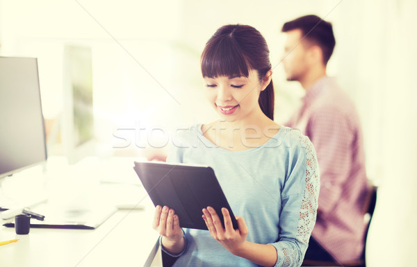 happy creative female office worker with tablet pc Stock photo © dolgachov