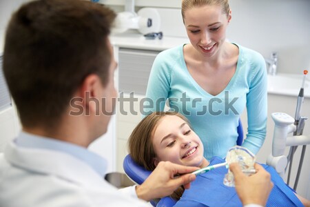 woman, baby and doctor with clipboard at clinic Stock photo © dolgachov