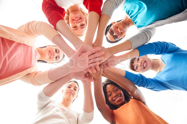 Stock photo: international group of women with hands together