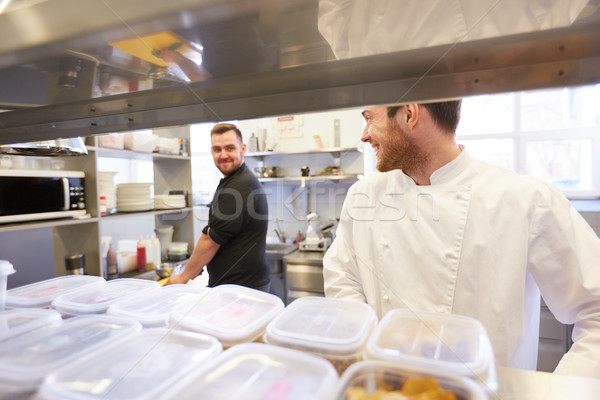 chef and cook cooking food at restaurant kitchen Stock photo © dolgachov