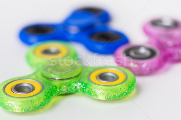 close up of fidget spinners on white background Stock photo © dolgachov