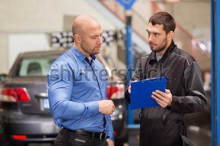 auto mechanic and customer looking at car Stock photo © dolgachov