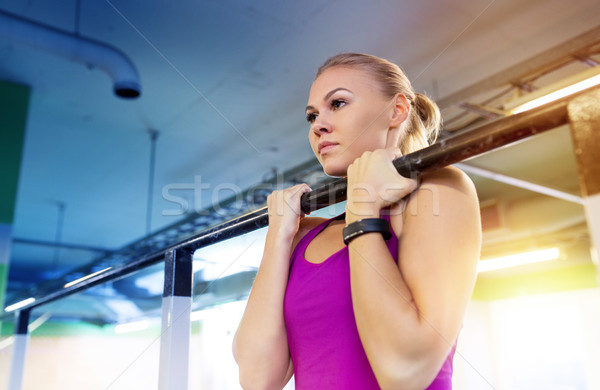 woman exercising and doing pull-ups in gym Stock photo © dolgachov