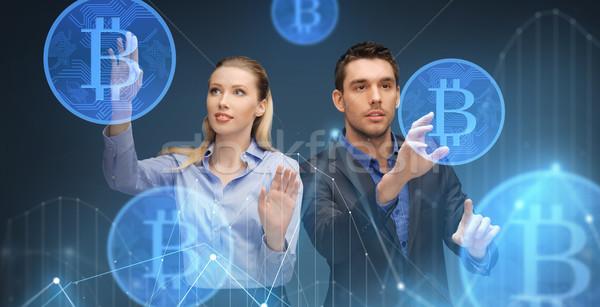 businessman and businesswoman with bitcoins Stock photo © dolgachov