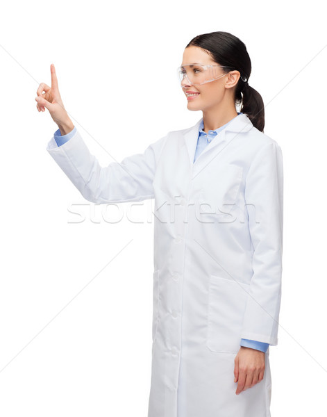 Glimlachend vrouwelijke arts wijzend iets gezondheidszorg Stockfoto © dolgachov