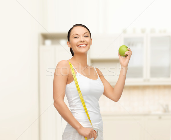 sporty woman with apple and measuring tape Stock photo © dolgachov