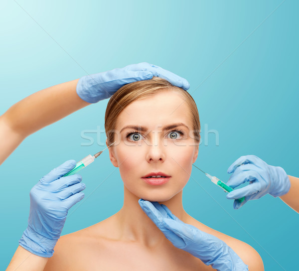 woman face and beautician hands with syringe Stock photo © dolgachov