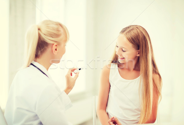 doctor with child measuring temperature Stock photo © dolgachov