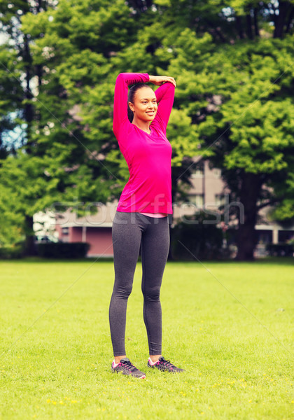 Souriant femme noire jambe extérieur fitness [[stock_photo]] © dolgachov