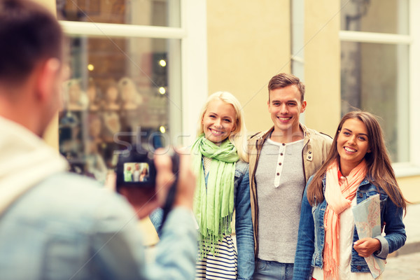 group of smiling friends taking photo outdoors Stock photo © dolgachov
