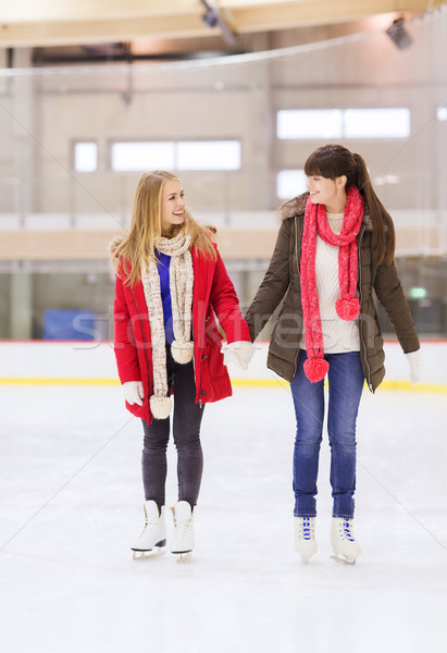 happy girls friends on skating rink Stock photo © dolgachov