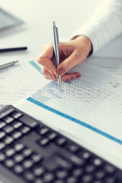 woman hand writing on paper with numbers Stock photo © dolgachov