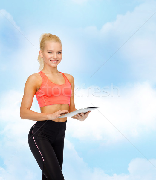 smiling sporty woman with tablet pc computer Stock photo © dolgachov