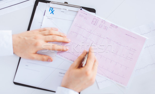 male doctor hands with cardiogram Stock photo © dolgachov