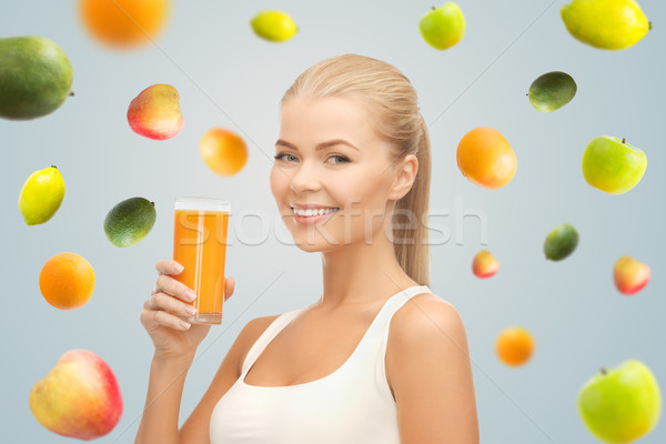 Felice donna vetro succo d'arancia Foto d'archivio © dolgachov