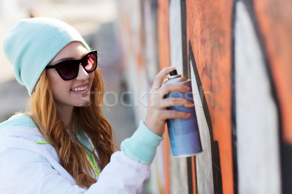 teenage girl drawing graffiti with spray paint Stock photo © dolgachov
