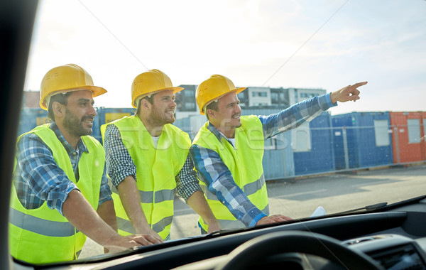 close up of builders with blueprint on car hood Stock photo © dolgachov