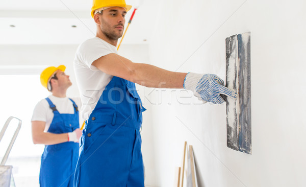 two builders with painting tools repairing room Stock photo © dolgachov
