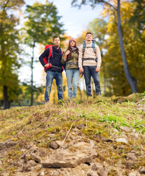 group of smiling friends with backpacks hiking Stock photo © dolgachov