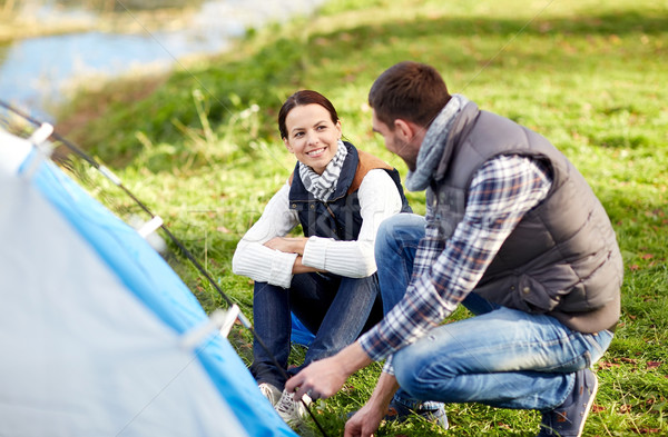 happy couple setting up tent outdoors Stock photo © dolgachov