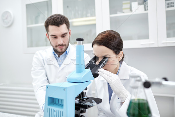 young scientists making test or research in lab Stock photo © dolgachov