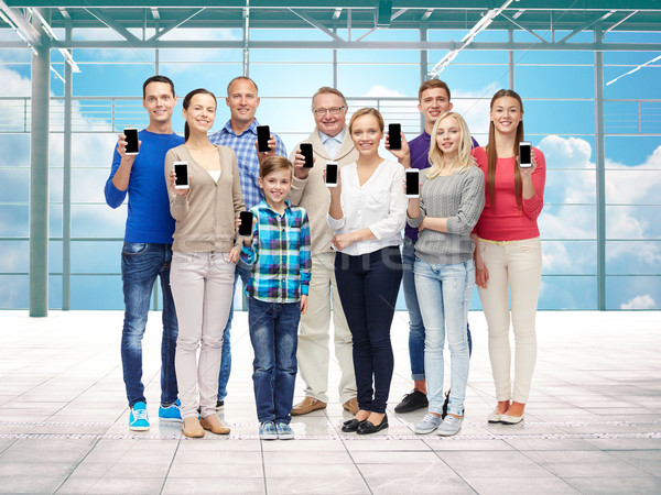group of smiling people with smartphones Stock photo © dolgachov