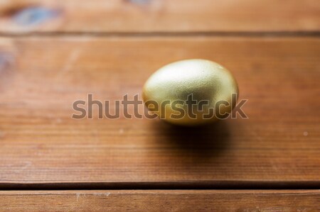 close up of golden easter egg on wood Stock photo © dolgachov