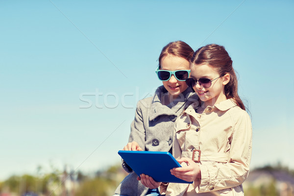 Stock photo: happy girls with tablet pc computer outdoors