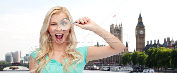 happy young woman with magnifying glass Stock photo © dolgachov