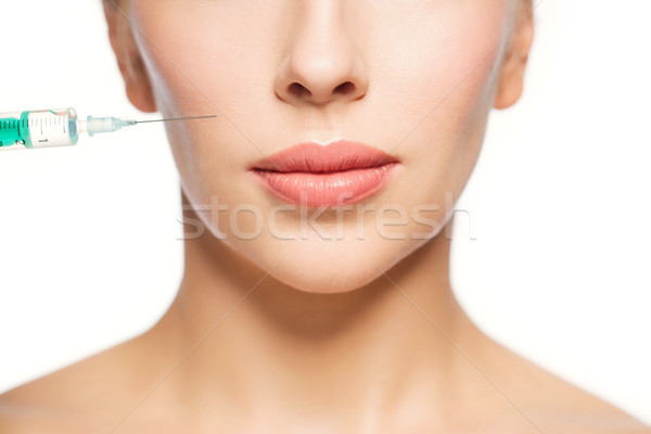 woman face and syringe making injection Stock photo © dolgachov