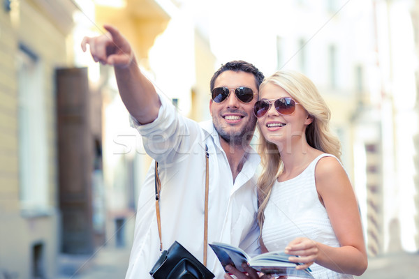 Stock photo: couple with map, camera and travellers guide